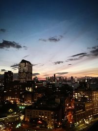 Illuminated cityscape against sky at night