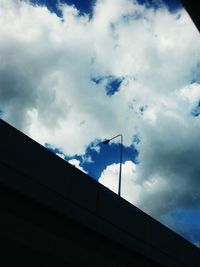 Low angle view of building against cloudy sky