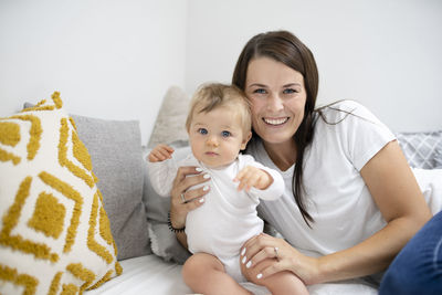 Portrait of mother and daughter at home