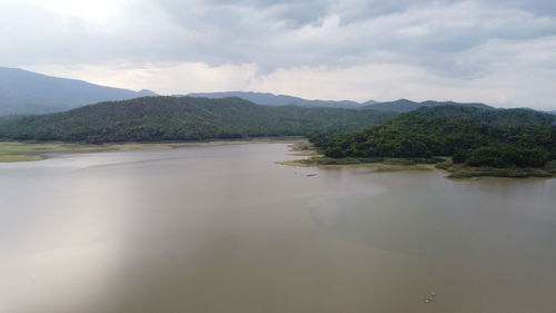 Scenic view of lake and mountains against sky