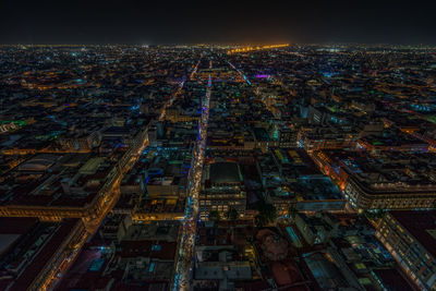 Illuminated cityscape against sky