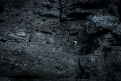 Young woman sitting on rock