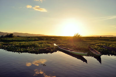 Scenic view of lake against sky during sunset