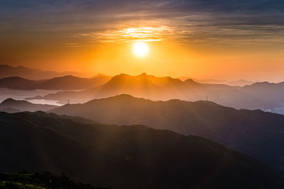 Scenic view of silhouette mountains against sky during sunset