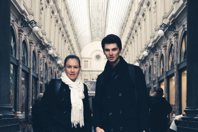 Portrait of couple standing at les galeries royales saint-hubert
