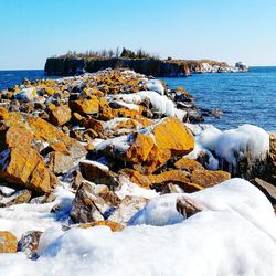 Scenic view of sea against clear blue sky