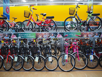 Bicycles parked against wall in city