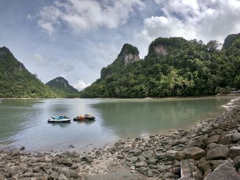 Scenic view of rocks in lake against sky