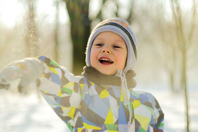 Close-up of smiling boy in snow