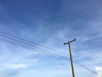 Low angle view of power lines against sky