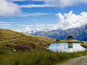 Scenic view of lake and mountains against sky