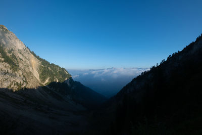 Scenic view of mountains against clear blue sky