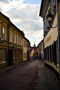 Street amidst buildings in city against sky