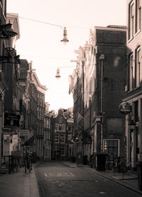 Street amidst buildings against sky in city