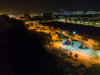 High angle view of city lit up at night