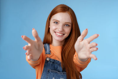 Smiling woman against blue background