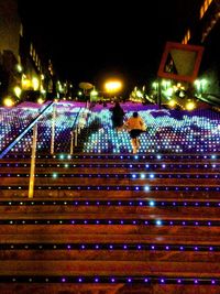 Illuminated street lights in city at night