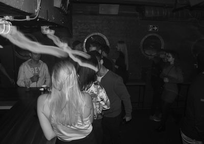 Rear view of people dancing at night