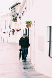 Man walking by building in city