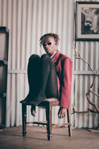 Portrait of young man sitting on chair