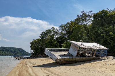 Built structure on beach against sky