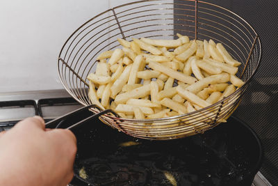 Close-up of person preparing food on barbecue grill