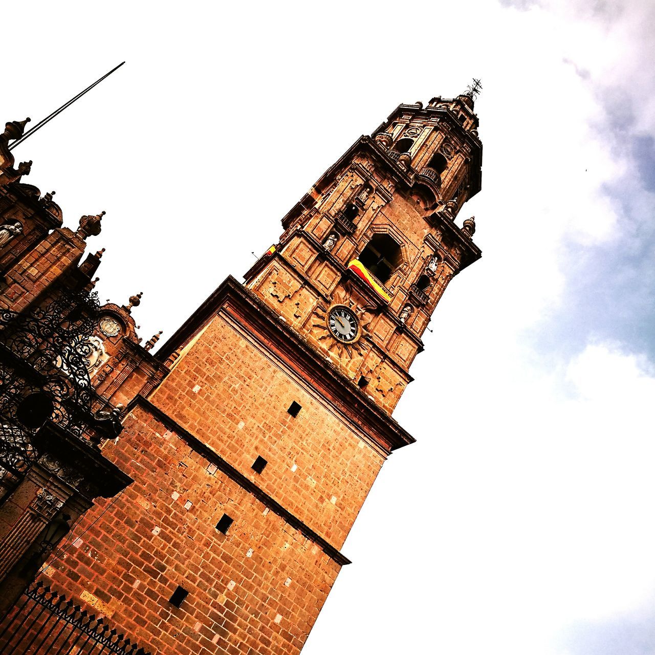 architecture, building exterior, built structure, low angle view, place of worship, religion, sky, spirituality, history, outdoors, no people, day, bell tower, clock tower, city, clear sky