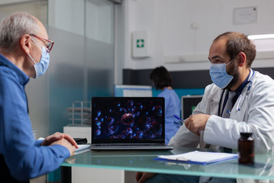 Side view of doctor working in office