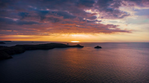 Scenic aerial view of sea against sky during sunset