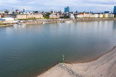 Bridge over river against buildings in city