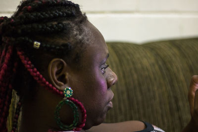 Close-up of woman with braided hair looking away