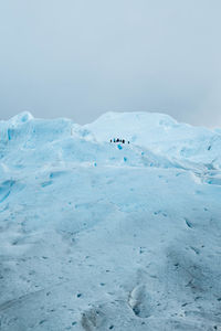 Glacier against cloudy sky