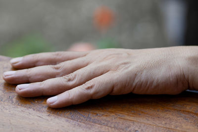 Close-up of hands on table