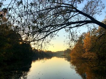 Scenic view of lake against sky at sunset