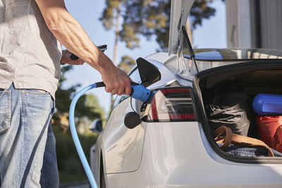 Man charging electric car