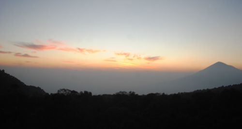 Scenic view of silhouette mountains against sky at sunset