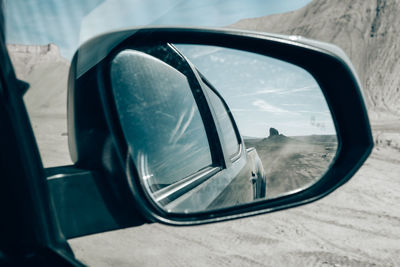 Side view mirror of a car traveling 