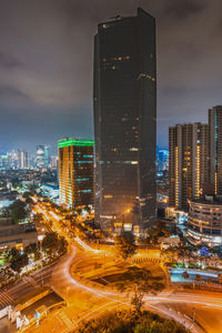 Illuminated buildings in city against sky