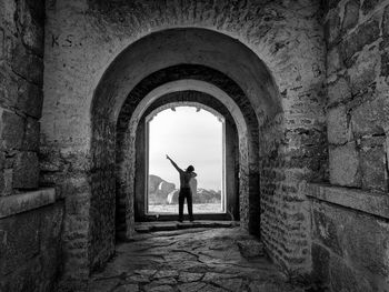 Full length of man standing by building against sky