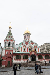 People at temple against sky