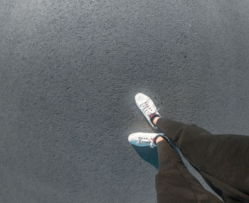 Low section of man standing on bottle