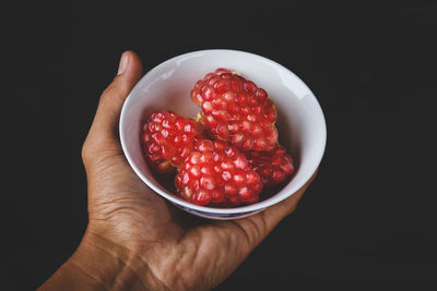 Close-up of hand holding strawberries