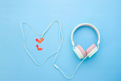 Directly above shot of heart shape on table against blue background