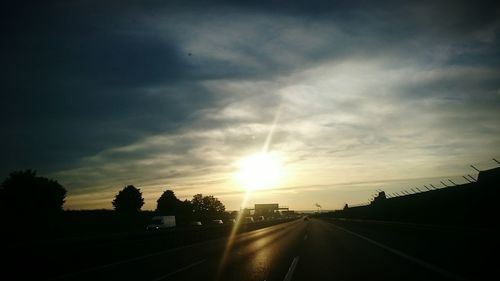 Road against cloudy sky at sunset