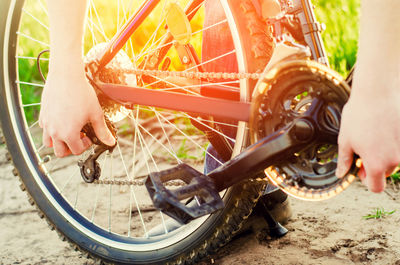 The guy repairs the bicycle. chain repair. cyclist. unratitude on the road, travel, close-up.