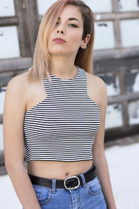 Smiling young woman wearing striped crop top