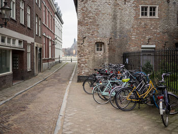 Bicycles parked on street against buildings in city