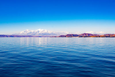 Scenic view of sea against blue sky