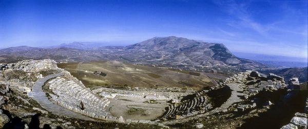 Scenic view of mountains against blue sky