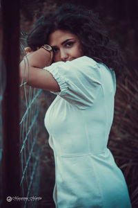 Portrait of young woman standing outdoors